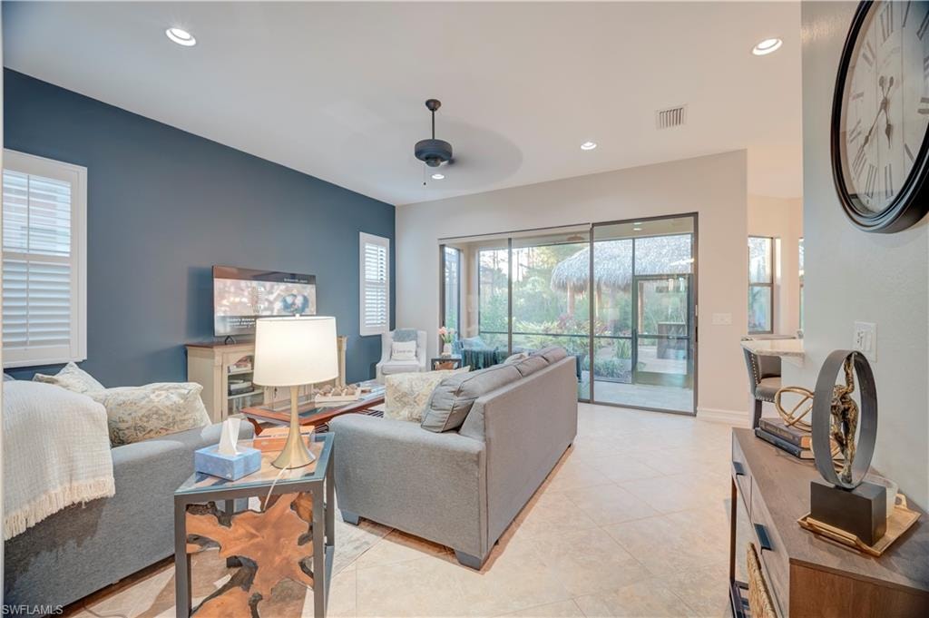 Living area with recessed lighting, a ceiling fan, and light tile patterned floors
