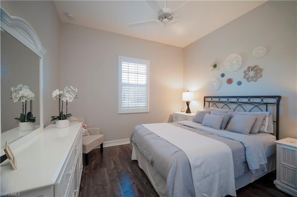 Bedroom with dark wood finished floors and ceiling fan