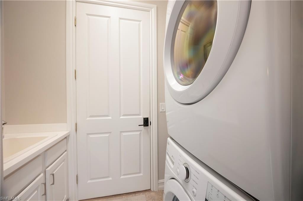 Laundry area with stacked washer and dryer