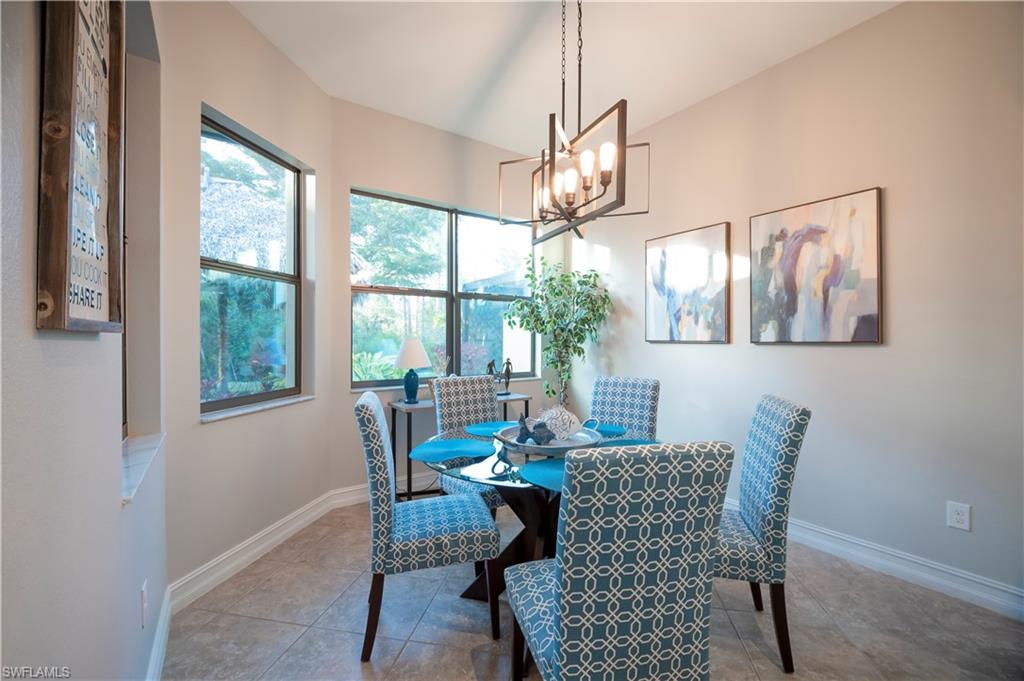 Dining space with baseboards and hanging lights