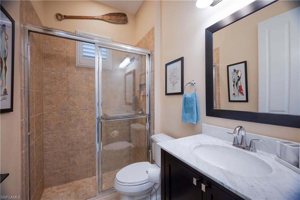 Full bathroom with vanity and a shower stall