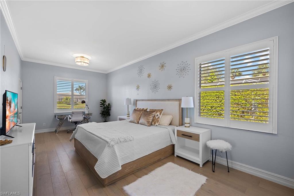 Bedroom featuring wood-type flooring and ornamental molding