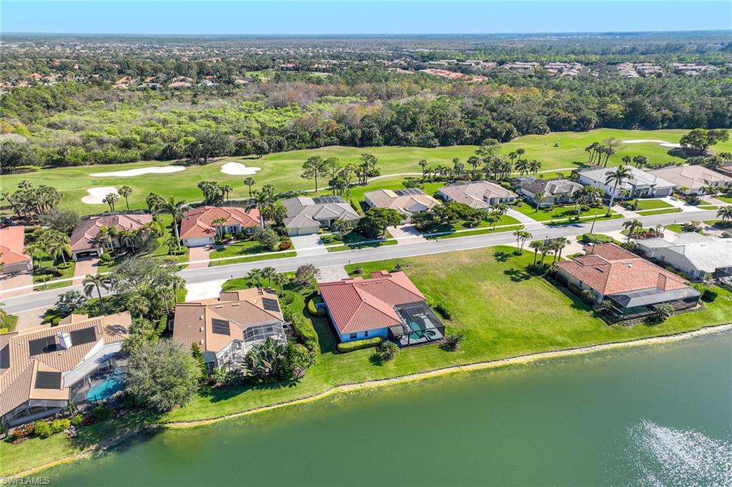 Aerial view of property's location with nearby suburban area and a golf course