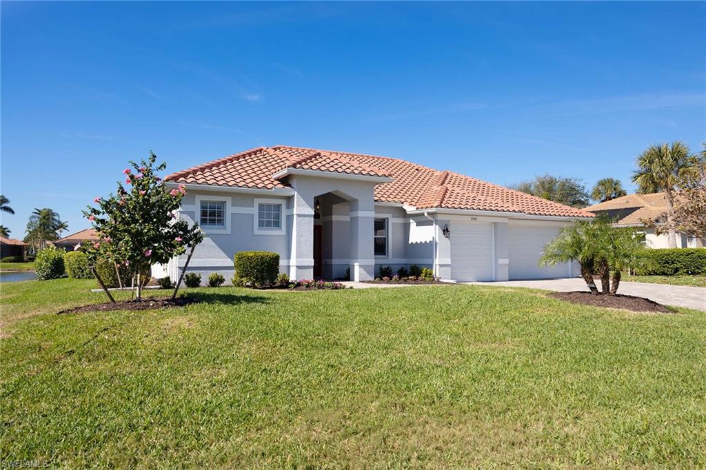 Mediterranean / spanish-style home featuring stucco siding, a tile roof, a front yard, concrete driveway, and a garage