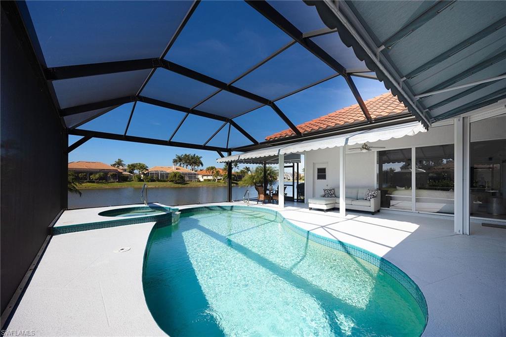 View of swimming pool with a sunroom, a patio, a lanai, and a pool with connected hot tub
