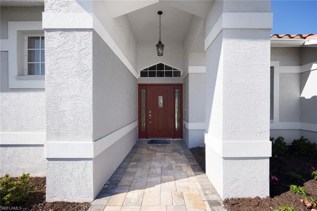 Doorway to property with stucco siding and a tiled roof