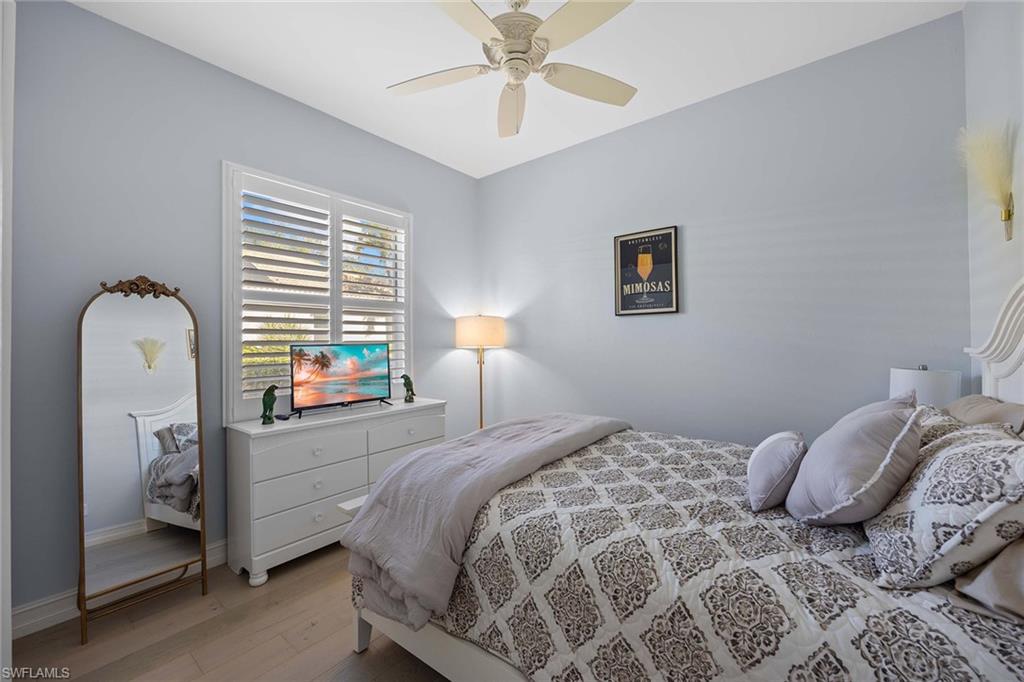 Bedroom with hardwood / wood-style floors and ceiling fan