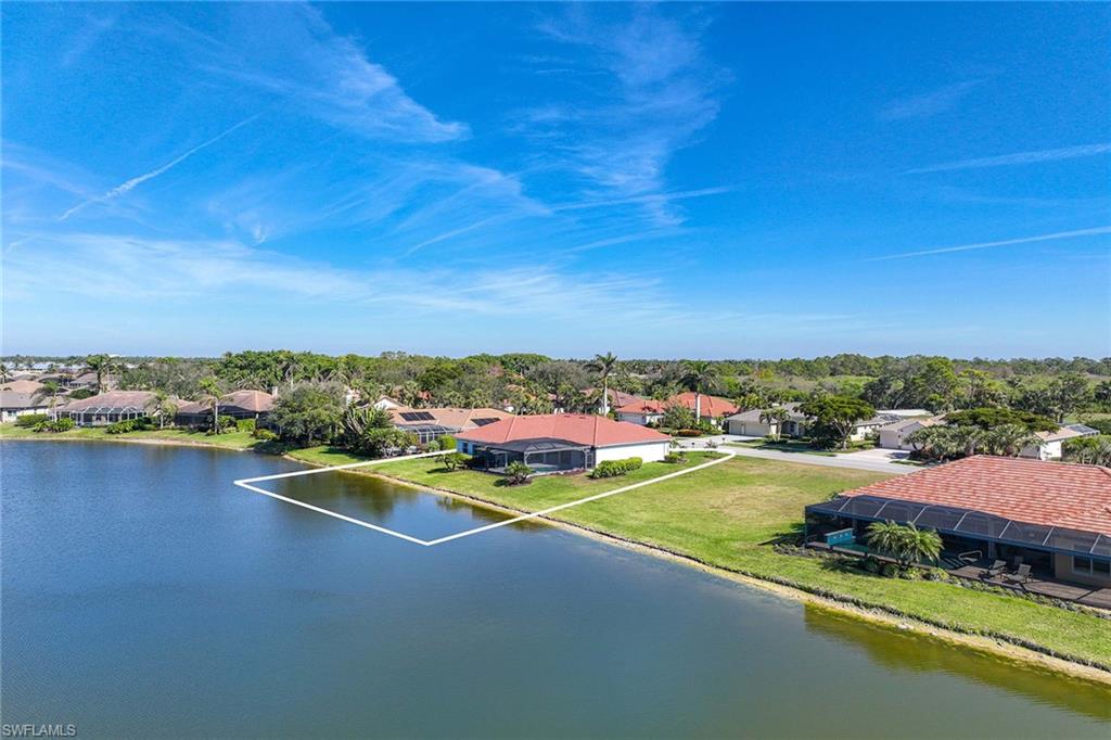 Aerial perspective of suburban area featuring a large body of water