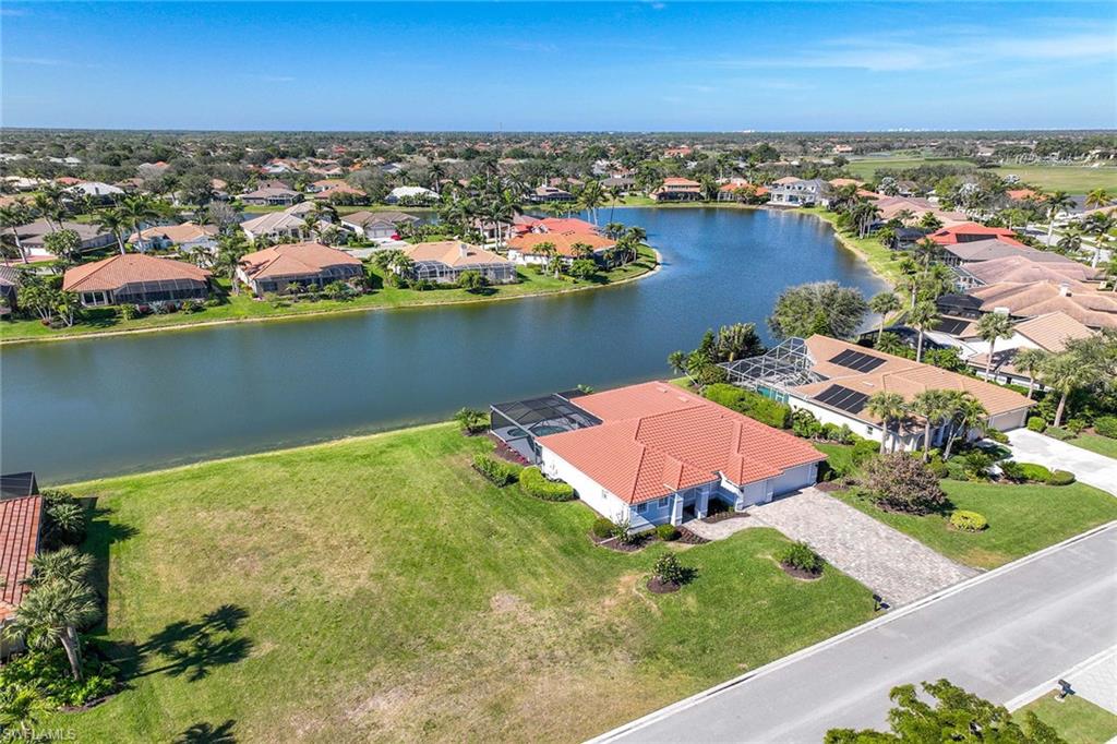 Aerial view of residential area featuring a large body of water