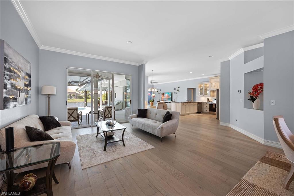 Living room featuring crown molding and light wood-style floors