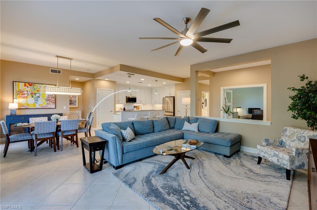 Living room, kitchen and dining area.  Above the half wall, is the entrance to the den in the main foyer entrance.