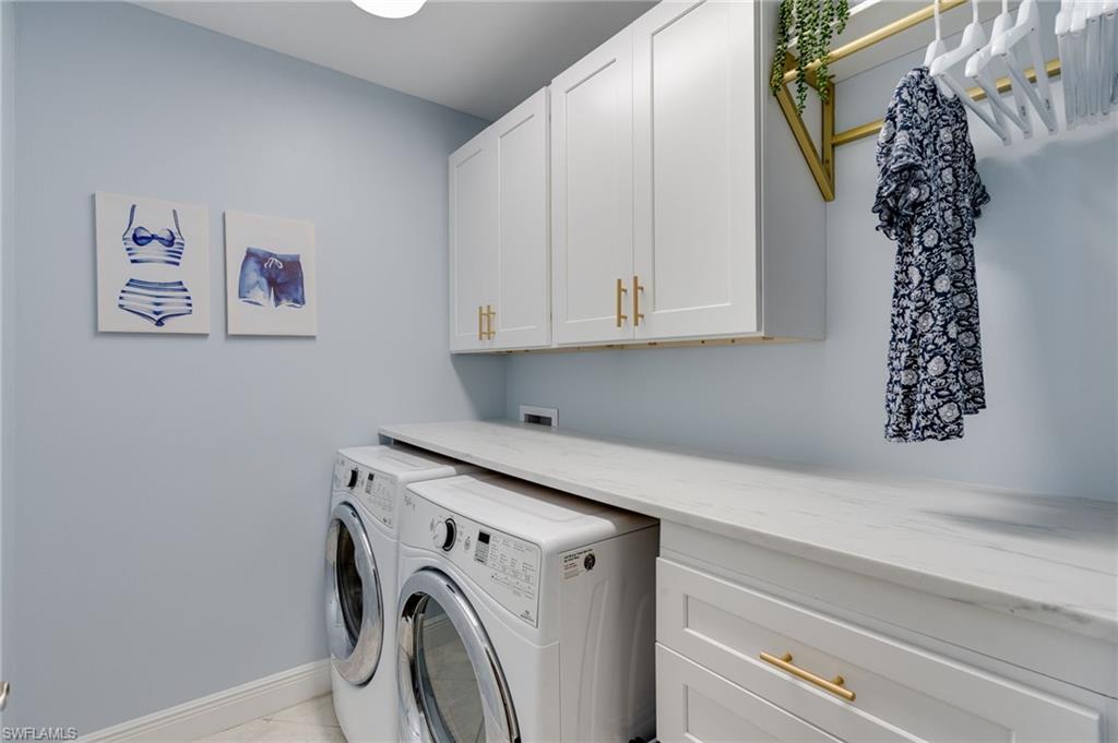 Laundry area featuring  NEW custom cabinets, folding surface, four drawers for organizing and dedicated rod to hang dry clothes.
