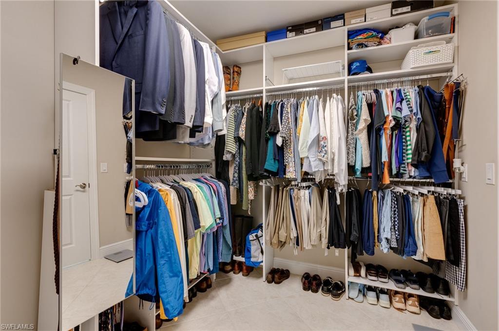 Huge primary walk-in closet with custom shelving to maximize storage.