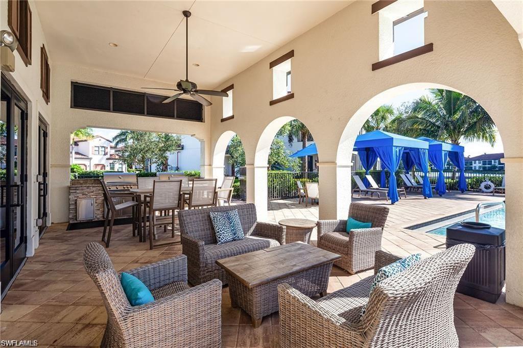 View of patio / terrace with a ceiling fan, outdoor lounge area, a community pool, and a grill