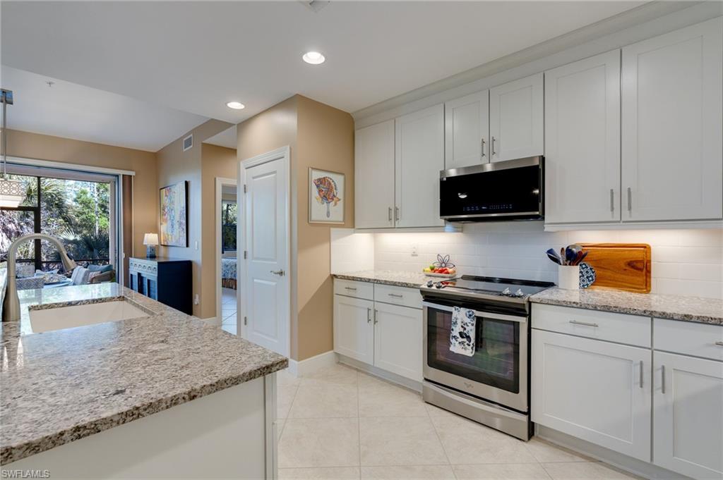 Kitchen featuring lots of light from two huge sliders.