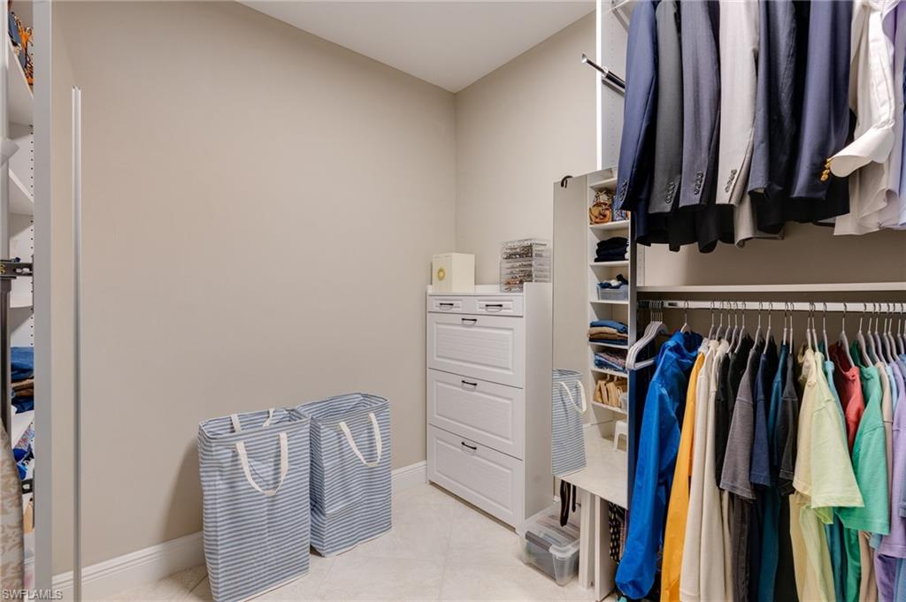 Primary walk-in closet featuring NEW LED flat panel lighting.