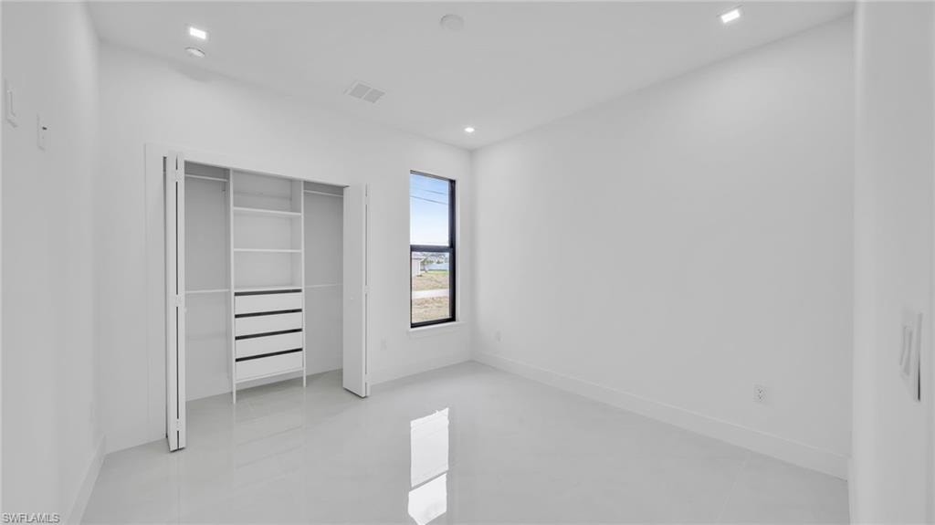 Unfurnished bedroom featuring a closet and recessed lighting