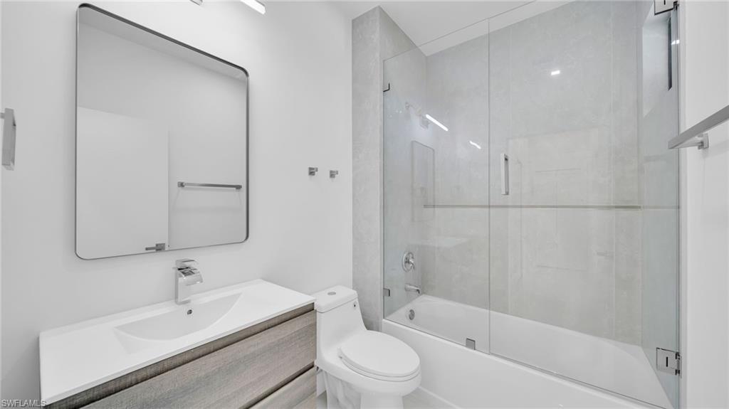 Full bath with vanity and enclosed tub / shower combo