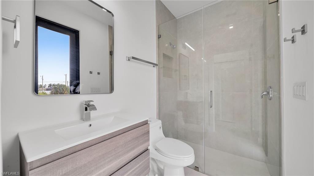 Bathroom with vanity and a shower stall