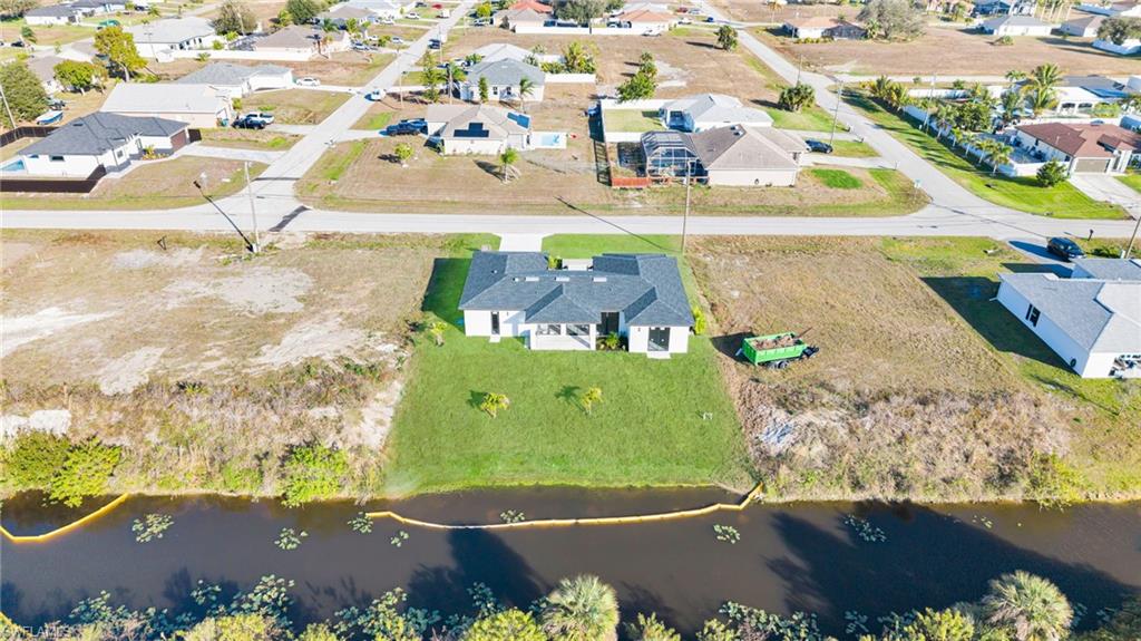 Aerial perspective of suburban area featuring a nearby body of water