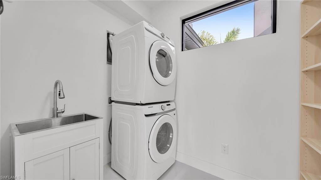 Washroom with stacked washing machine and dryer