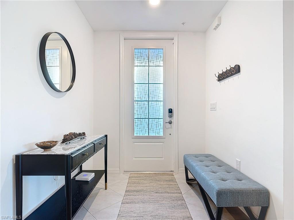 Doorway with light tile patterned floors
