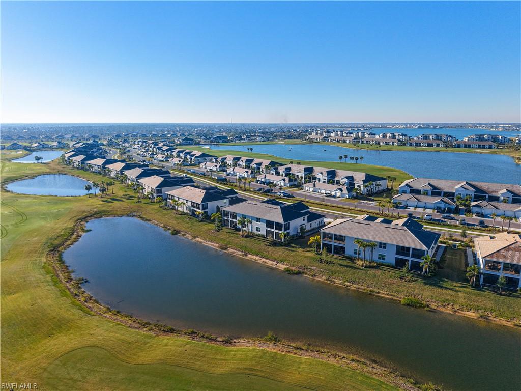 Birds eye view of property with a water view