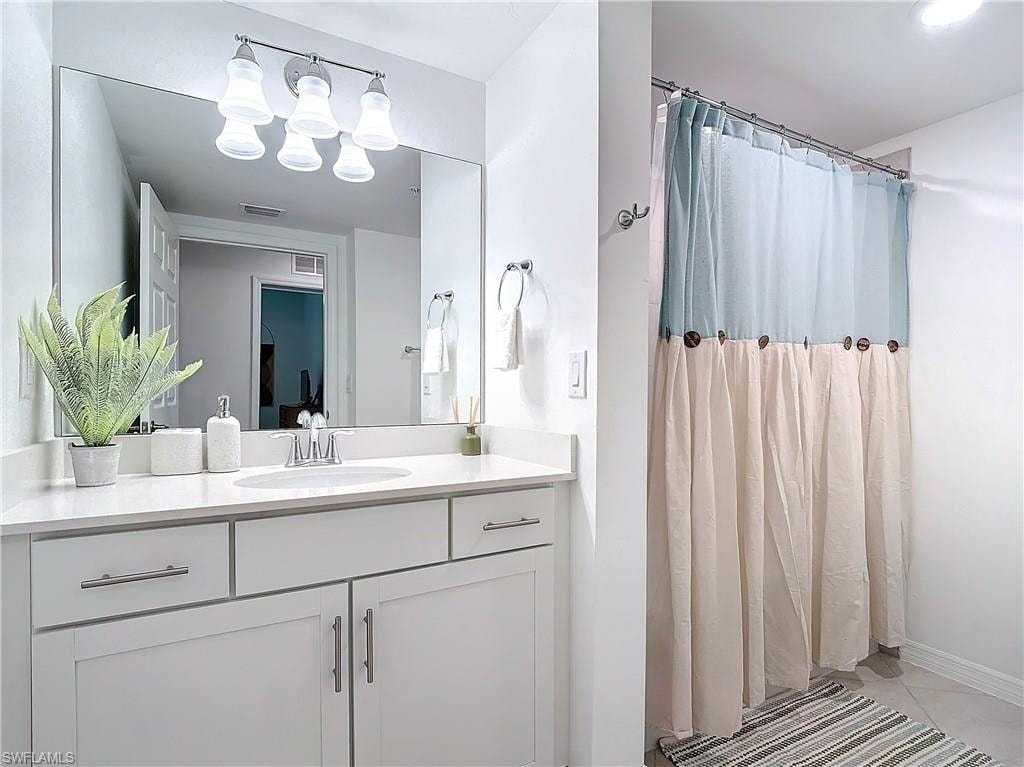 Bathroom featuring vanity and tile patterned floors