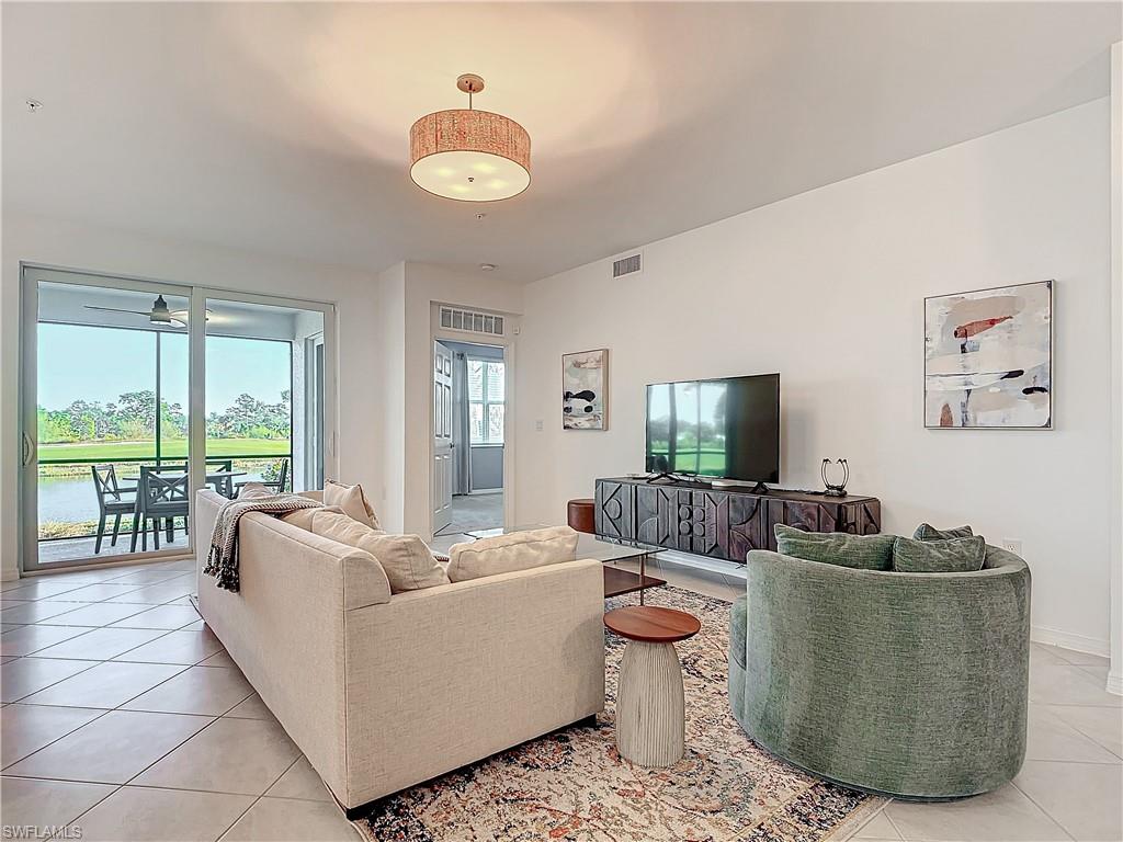 Tiled living room featuring a water view