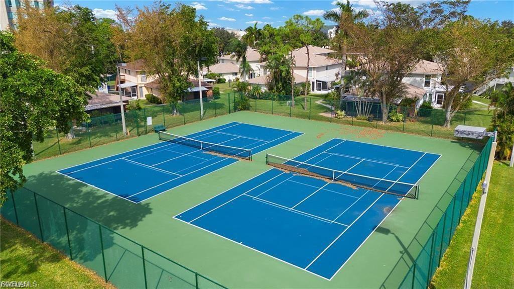 View of tennis court featuring a residential view