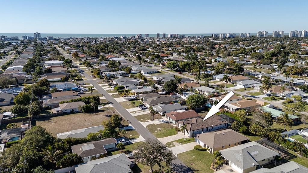 Aerial overview of property's location featuring nearby suburban area and a large body of water