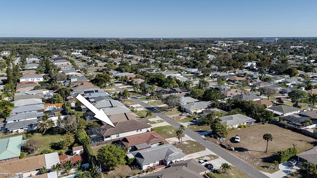 Aerial view of property's location featuring nearby suburban area