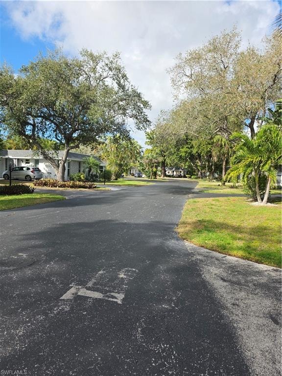 View of asphalt street featuring a residential view