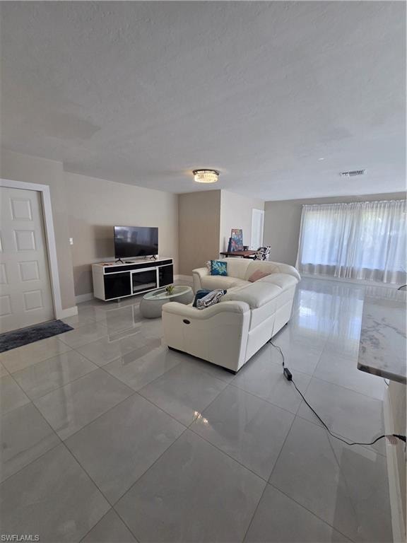 Living room featuring light tile patterned floors