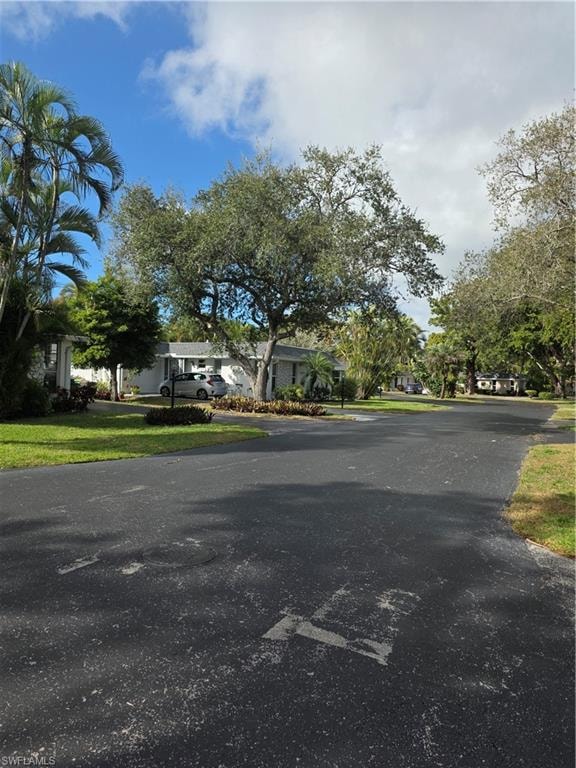 View of asphalt street featuring a residential view