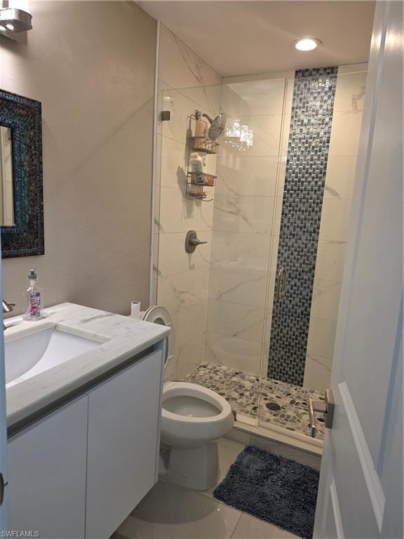 Full bathroom with a shower stall, vanity, and tile patterned floors