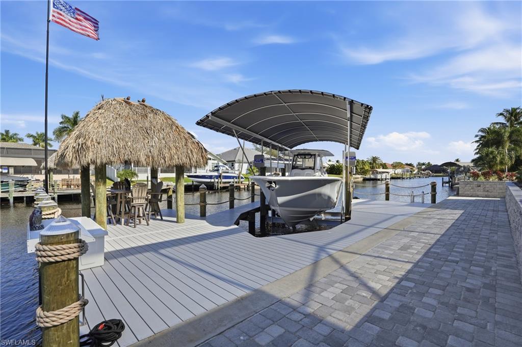 Dock featuring boat lift and a water view