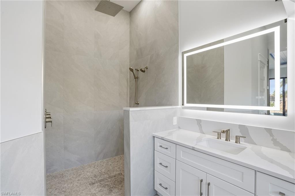 Full bathroom with vanity and walk in shower