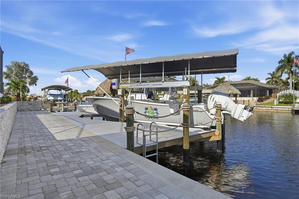 Dock area featuring a water view and boat lift