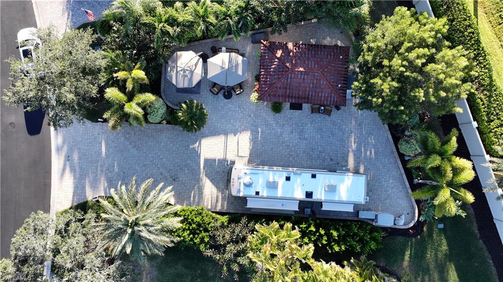 Aerial view of property and surrounding area featuring a pool