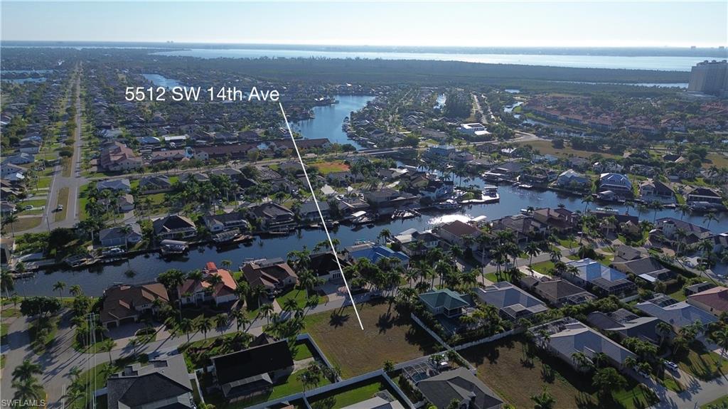 Aerial view of property's location featuring nearby suburban area and a large body of water