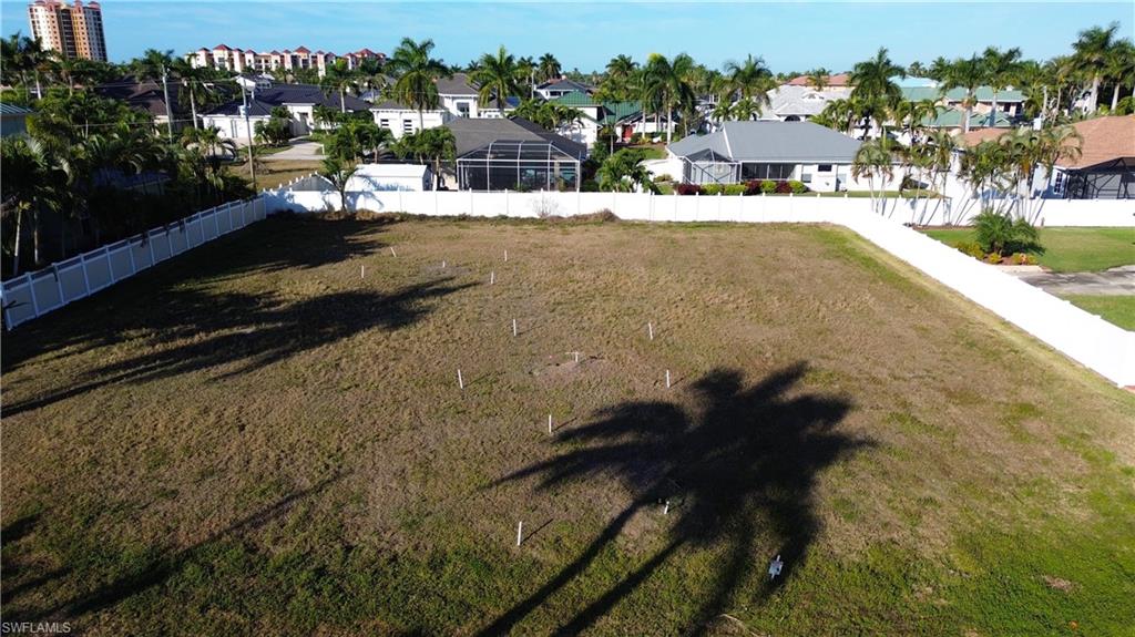 Fenced backyard featuring a residential view