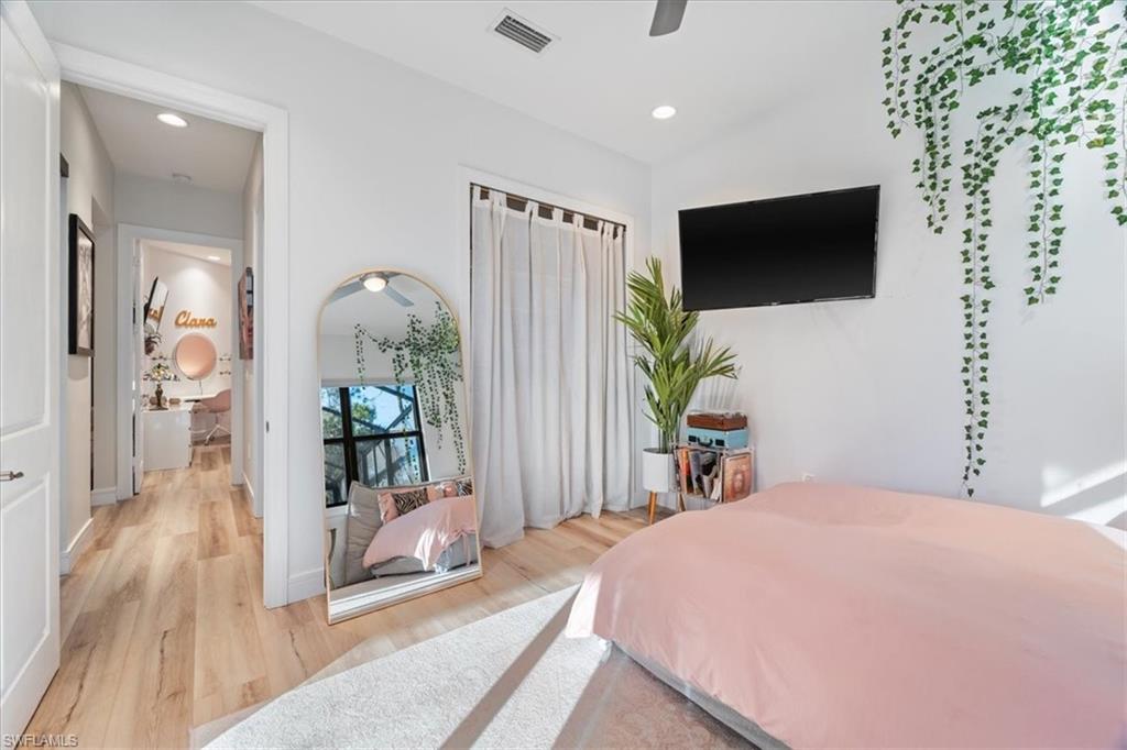 Bedroom featuring baseboards, recessed lighting, a ceiling fan, visible vents, and wood finished floors