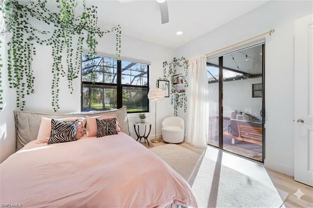 Bedroom with access to exterior, a ceiling fan, light wood finished floors, and recessed lighting