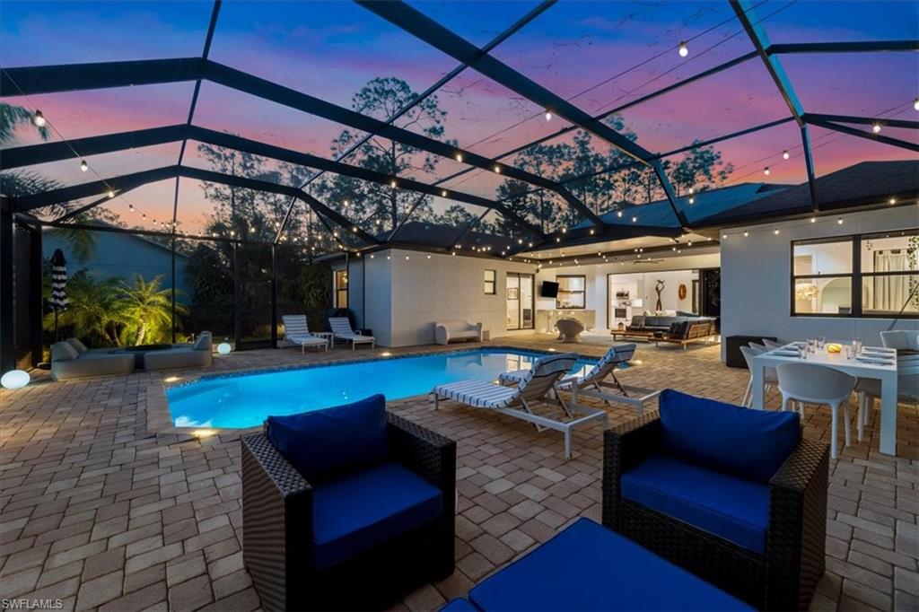 Outdoor pool with outdoor lounge area, outdoor dining space, a patio, and a lanai