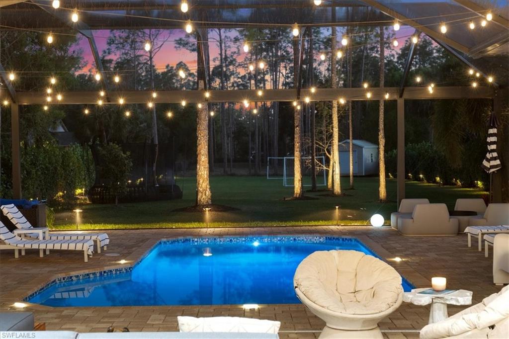 Outdoor pool with a yard, a patio area, a shed, and an outdoor living space