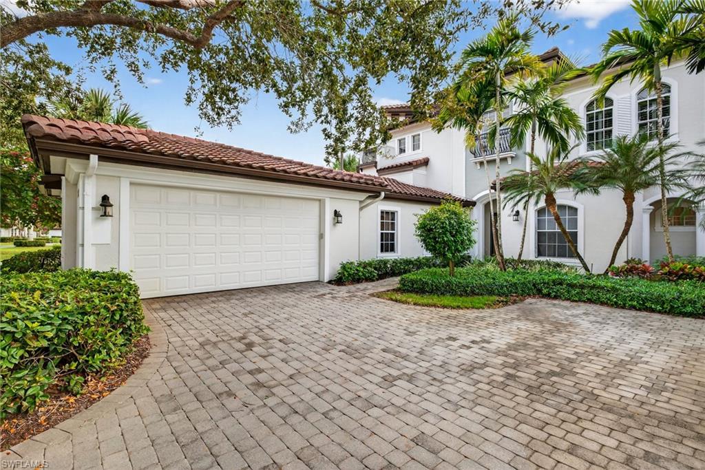 Mediterranean / spanish home featuring stucco siding, decorative driveway, a garage, and a tile roof
