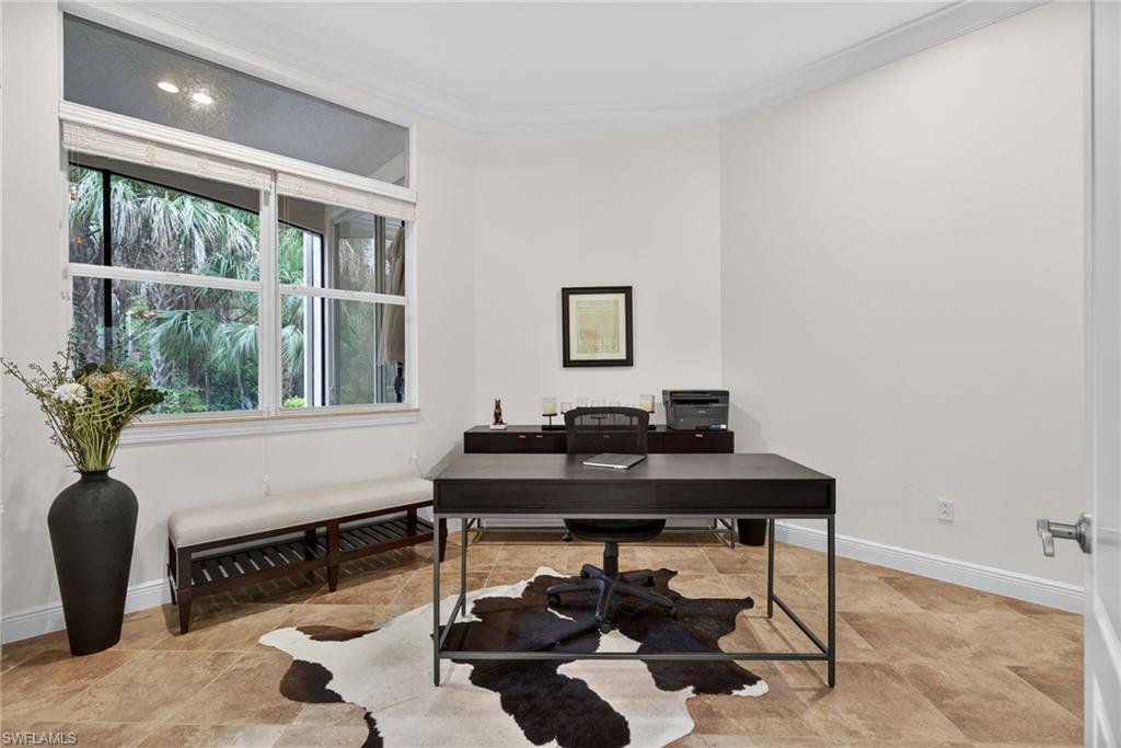 Office area with ornamental molding and baseboards
