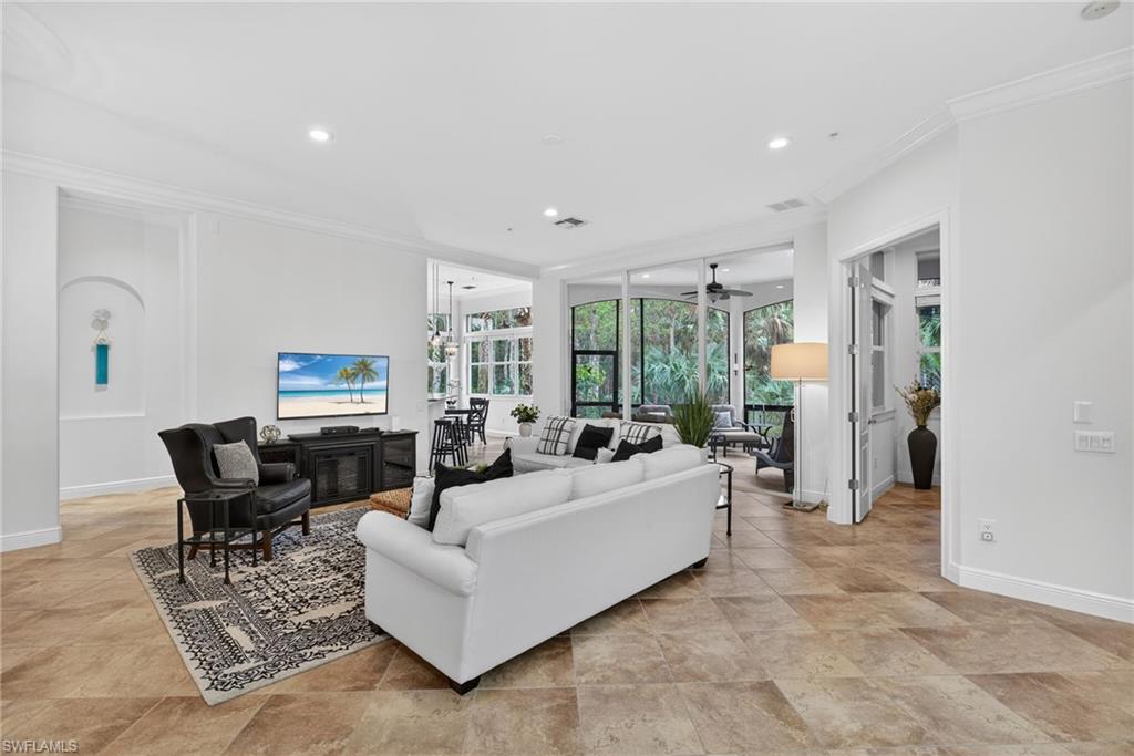 Living area featuring crown molding, recessed lighting, and ceiling fan