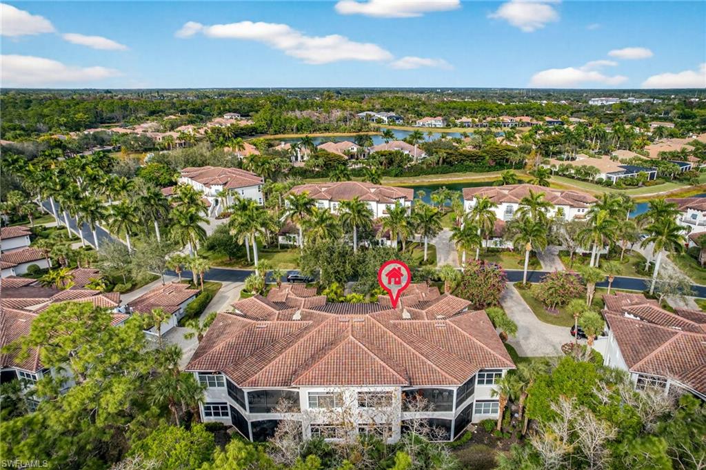 Aerial view of property and surrounding area featuring nearby suburban area